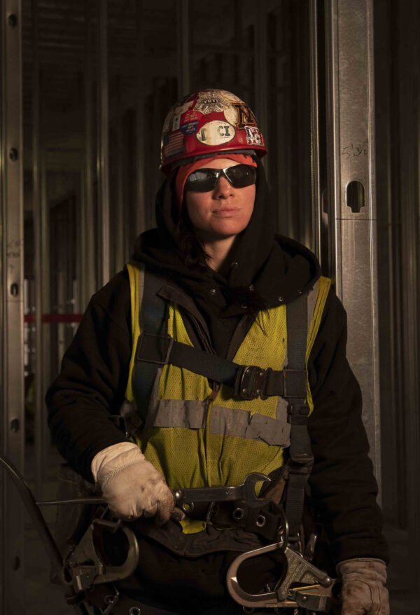 female iron worker constructing high rise